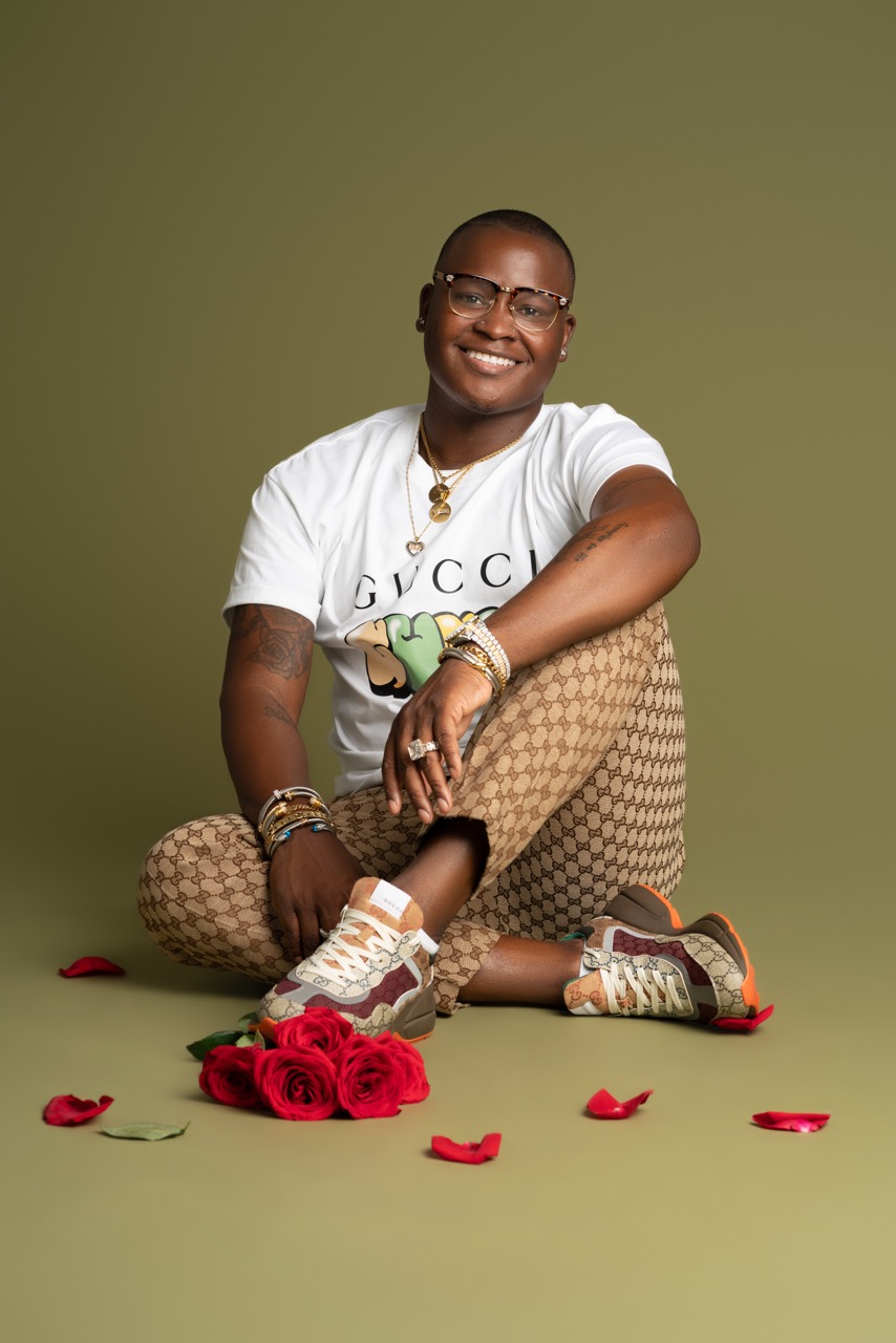 Model poses with flowers wearing Gucci from head to toe and glasses at Mild Studios, Toronto, Ontario
