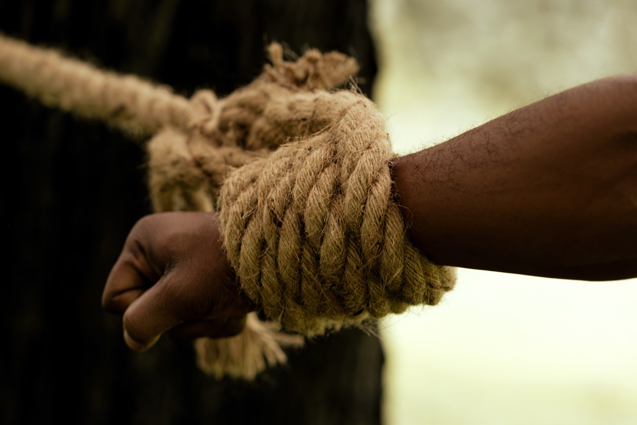 Close up of a hand tied at the wrist with thick rope outdoors. Freedom, a shoot by Nissi Pululu of Sonset Inc in Toronto
